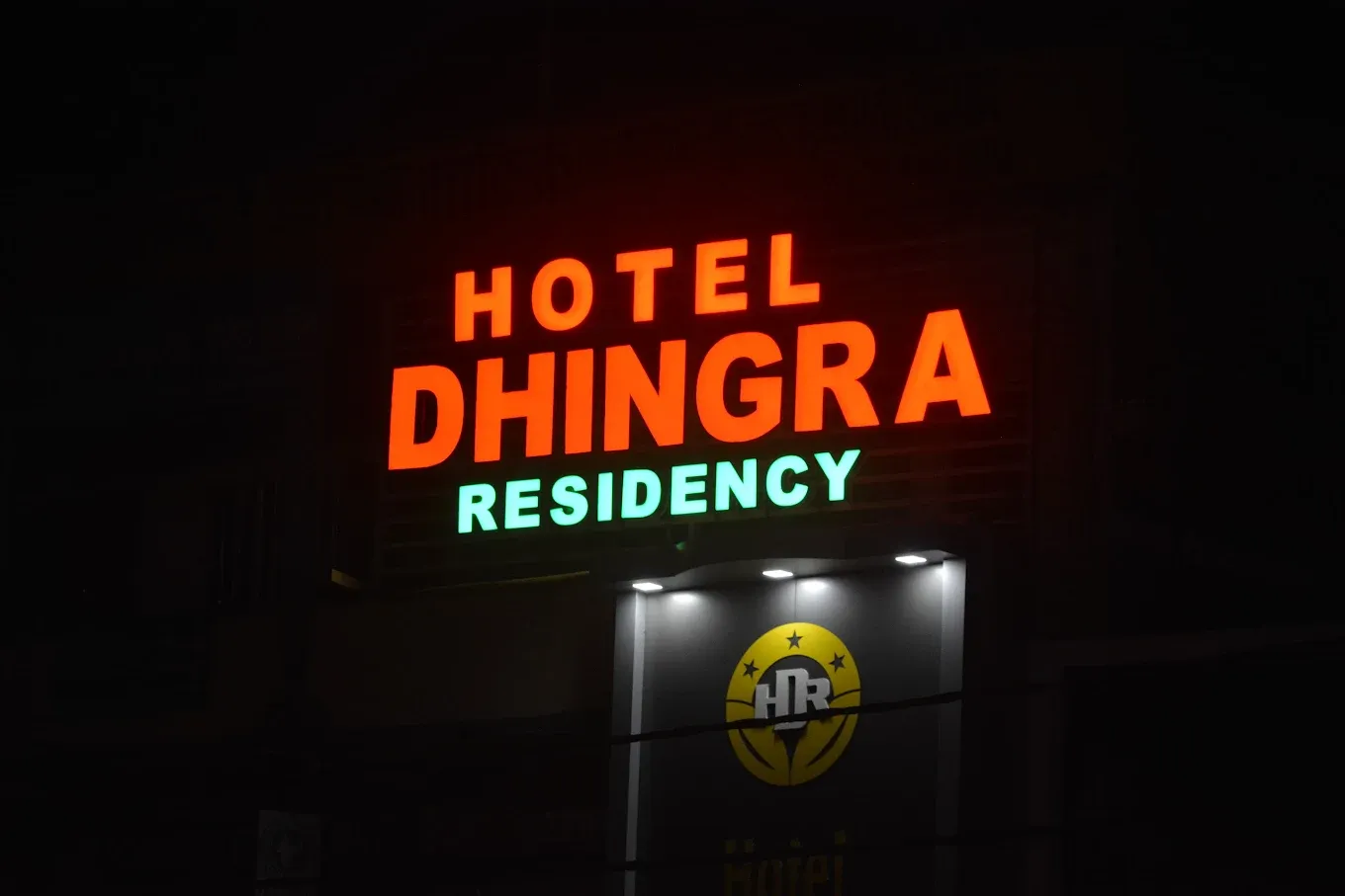 Hotel Dhingra Residency sign glowing at night in Vijay Nagar, Jabalpur