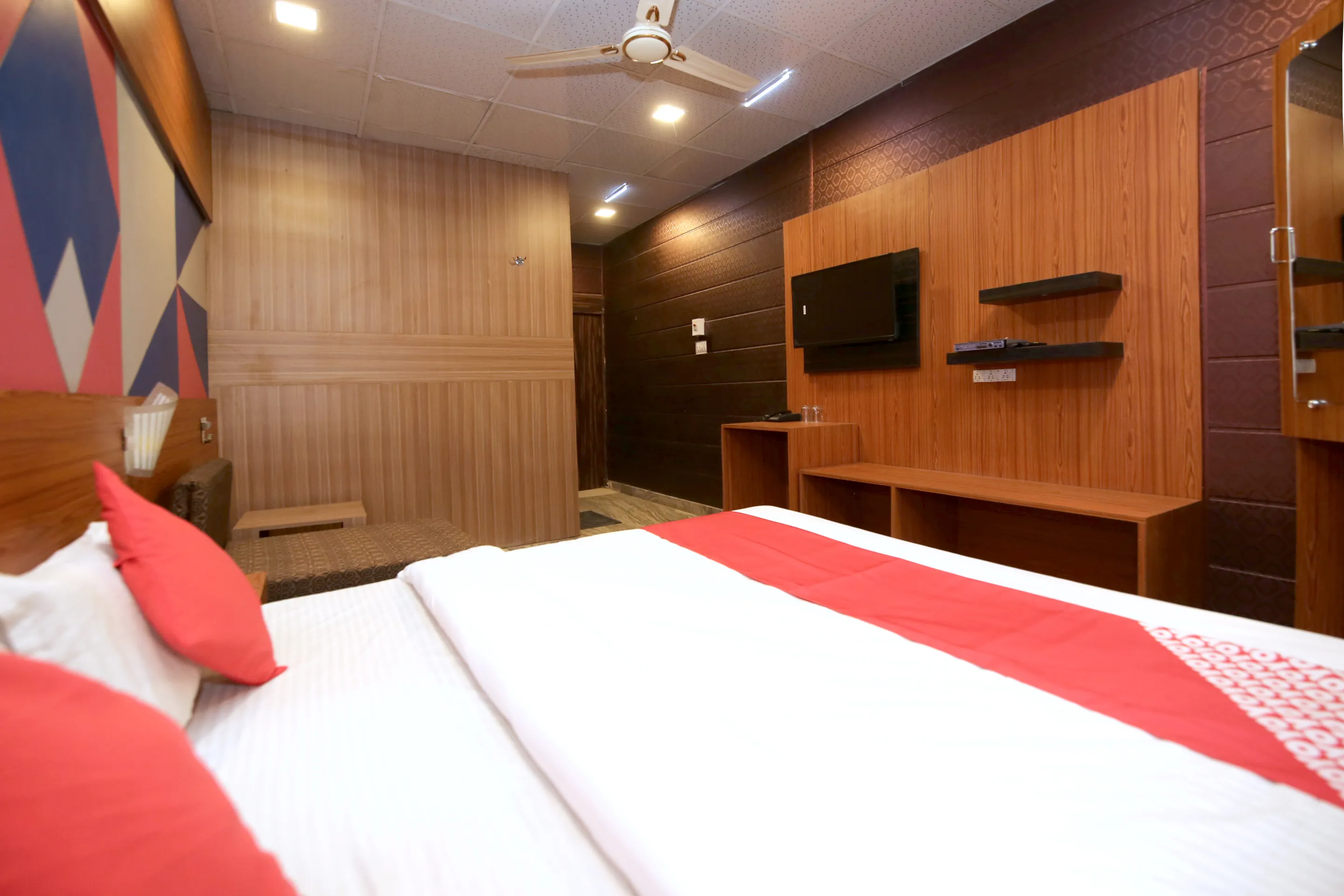 Double room with smart TV and wood-panel walls